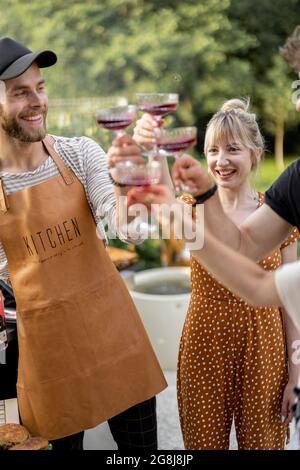 Friends celebrating with alcohol drinks outdoors Stock Photo