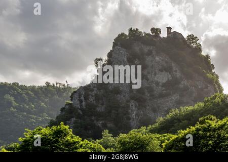 Bottom view of the Rock of Prayer of Roccaporena, Cascia, Italy, or Sacro Scoglio, under a dramatic sky Stock Photo