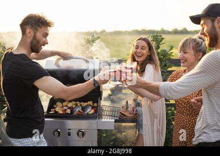 Friends having fun at picnic outdoors Stock Photo