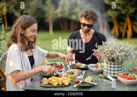 Couple having lunch with healthy food outdoors Stock Photo