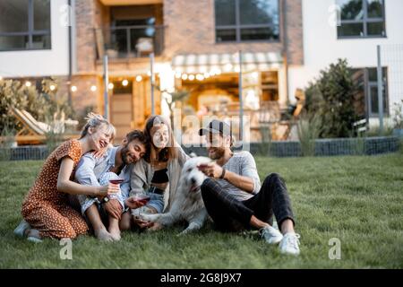 Friends having fun at backyard in the evening Stock Photo
