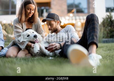 Friends having fun at backyard in the evening Stock Photo