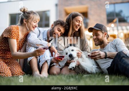 Friends having fun at backyard in the evening Stock Photo