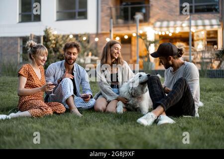 Friends having fun at backyard in the evening Stock Photo