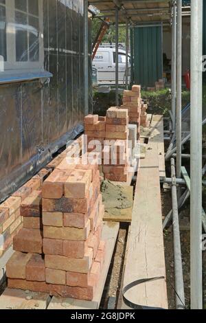 red bricks are stacked wall /pile of orange bricks baked clay ...