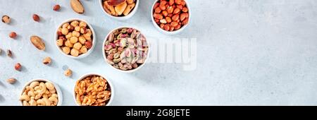 Nuts panorama with a place for text or logo, top shot. Pistachios, walnuts and many other nuts Stock Photo