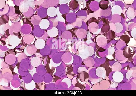 Purple, white and golden round paper confetti party background, top view Stock Photo