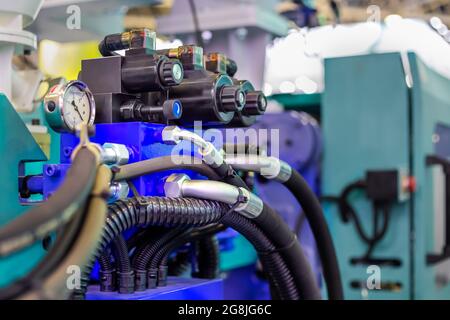 Part of automatic injection molding machine and plastic hoses at exhibition Stock Photo