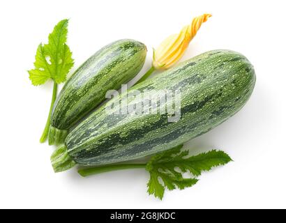 Zucchini isolated on white background. Composition with yellow flower and green leaves. View from above Stock Photo