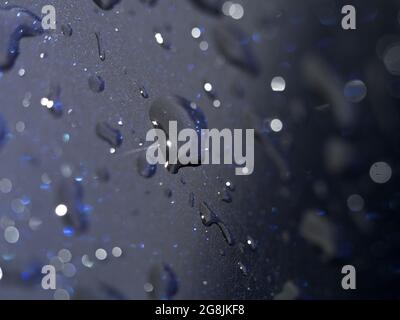 Some raindrops on blue metal Stock Photo