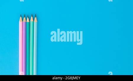 Some pencils on blue background with copyspace, top view Stock Photo