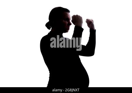 Screaming angry young pregnant woman. Silhouette view Stock Photo