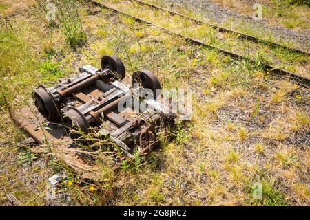 Old rusty industrial heritage rail bogie on wasteland, UK Stock Photo