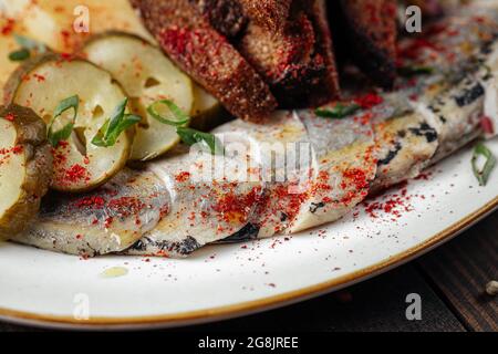 Traditional russian snacks with herring and pickle Stock Photo