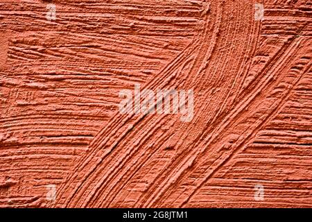 Red plaster wall exterior with grainy texture Stock Photo