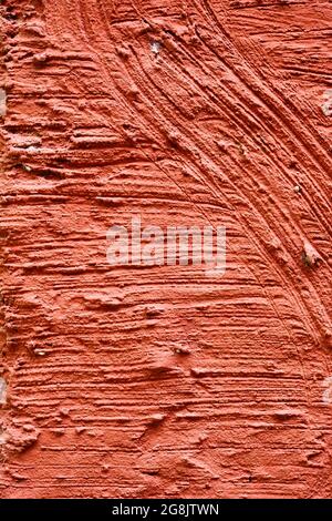 Red plaster wall exterior with grainy texture Stock Photo