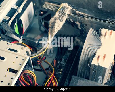 Heavy dust buildup on the components of system unit case. Concept of computer care and maintenance Stock Photo