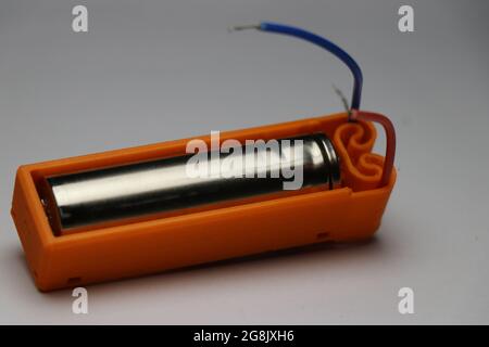 Shiny lithium ion battery kept inside battery holder use to power various electronics project Stock Photo