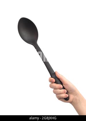 Black plastic ladle in hand, isolated on a white background Stock Photo