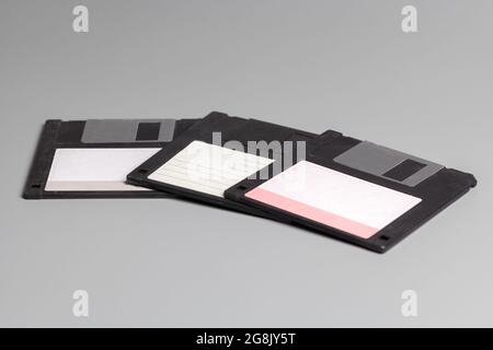 Three old computer diskette over grey background Stock Photo