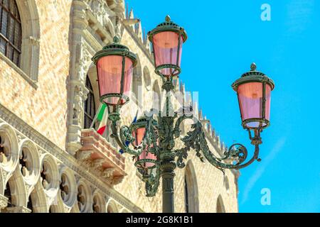 Details of Venetian famous street lamps of the San Marco square in Venice city downtown. Saint Mark Italian square of Venice city of Italy with Doge's Stock Photo