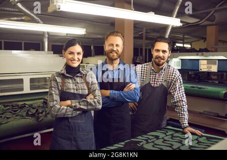 Portrait of a group of skilled happy male and female shoemakers at a shoe or garment factory. Stock Photo