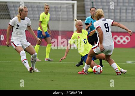 Tokyo, Japan. 21st July, 2021. Sweden midfielder Caroline Seger (17) fights for the ball with United States midfielder Lindsey Horan (9) and United States midfielder Samantha Mewis (3) during a Women's Group G football match at Tokyo Stadium during the Tokyo Summer Olympic Games in Tokyo, Japan, on Wednesday July 21, 2021. Photo by Richard Ellis/UPI Credit: UPI/Alamy Live News Stock Photo