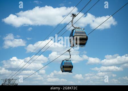 Cable car cabins against amazing sky and clouds. Cableway, green transportation.  Stock Photo