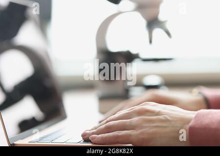 Female hands typing on laptop keyboard closeup Stock Photo
