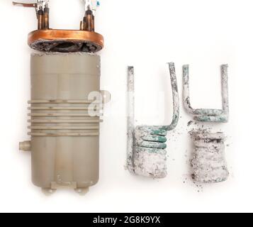 Bathroom shower heater, brocken apart to reveal scaled up interior with limescale deposits following 20 years of use, Herts, Beds. UK Stock Photo