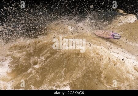 Munich, Germany. 21st July, 2021. A surfboard floats on the water after the departure of Australian-born Keegan on the Eisbach wave in the English Garden. The artificial wave is considered a popular hotspot for surfers and spectators all year round. Credit: Peter Kneffel/dpa/Alamy Live News Stock Photo