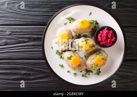 Gefilte Fish Boiled fishballs served with horseradish and carrots close-up in a plate on the table. horizontal top view from above Stock Photo