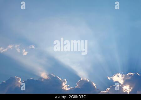 Fantastic Sunbeam Shining Through the Fluffy Clouds Stock Photo
