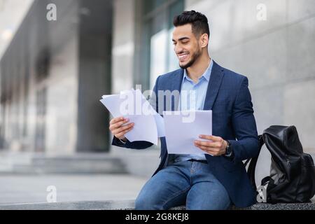 Excited young arab man getting ready for job interview Stock Photo
