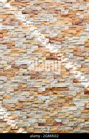 Abstract brown and white rock stone wall texture. Striped shadow and light on stone wall or stonework background. Home, Residential building. Stock Photo