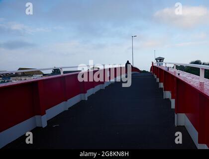 Red foot and bicycle bridge seen in Littlehampton, West Sussex, England, UK. Stock Photo