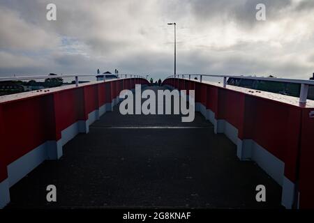 Red foot and bicycle bridge seen in Littlehampton, West Sussex, England, UK. Stock Photo