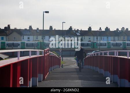 Red foot and bicycle bridge seen in Littlehampton, West Sussex, England, UK. Stock Photo