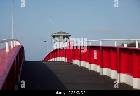 Red foot and bicycle bridge seen in Littlehampton, West Sussex, England, UK. Stock Photo