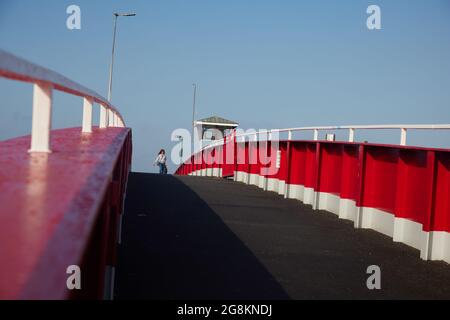 Red foot and bicycle bridge seen in Littlehampton, West Sussex, England, UK. Stock Photo