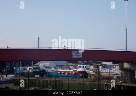 Red foot and bicycle bridge seen in Littlehampton, West Sussex, England, UK. Stock Photo