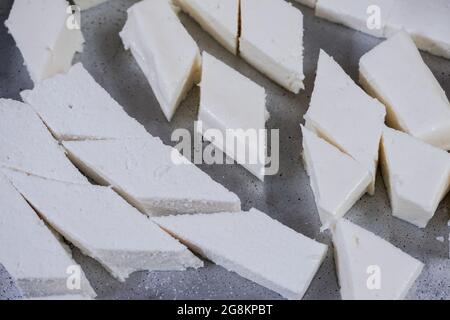 Cubes of fresh white paneer on a plate Stock Photo