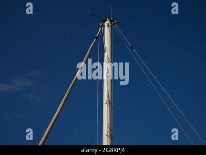 Mast and rope of sailing boat creating triangles. Stock Photo