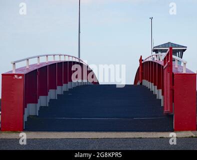 Red foot and bicycle bridge seen in Littlehampton, West Sussex, England, UK. Stock Photo