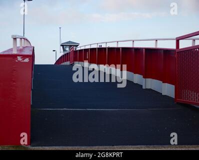 Red foot and bicycle bridge seen in Littlehampton, West Sussex, England, UK. Stock Photo