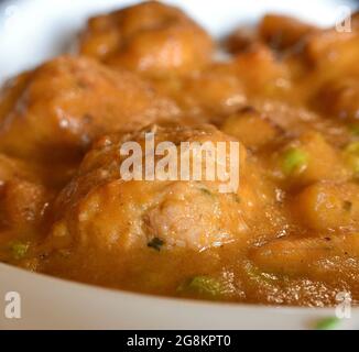 Macro detail of meatballs in garden sauce. Eat rich in a rural restaurant with local products. Stock Photo