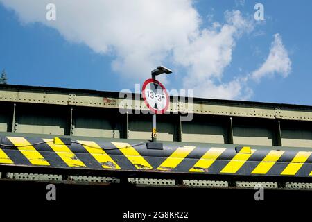 Height limit sign and chevrons on a railway bridge, Warwick, UK Stock Photo