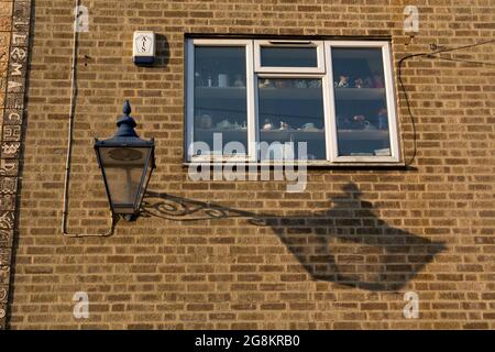 A lamp and its shadow on a wall, Warwick, UK Stock Photo