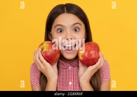 surprised kid hold healthy apple fruit with vitamin, toothy Stock Photo