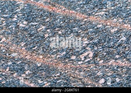 Sea stone texture. Background fill. Natural stone background. Panel texture. Spots gray red background. Stock Photo